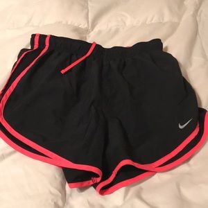 Neon pink and black Nike running shorts